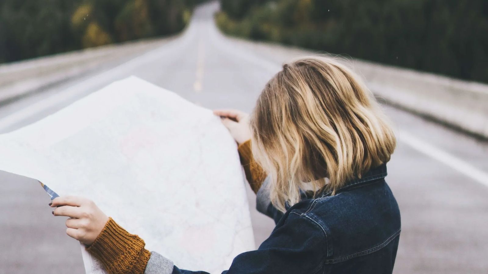 Woman looks at a map on the road to financial peace.